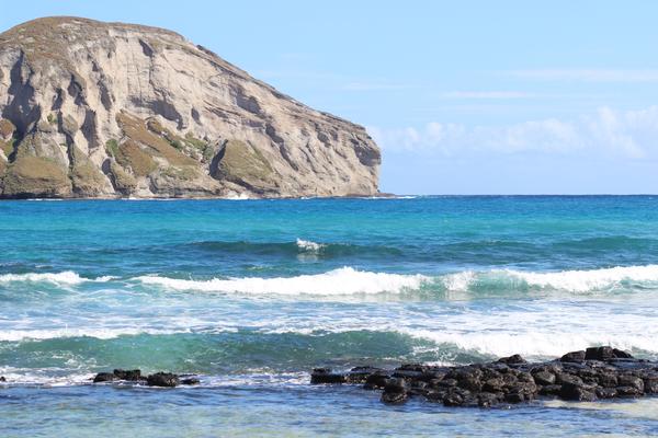 Ocean waves crashing on the shore on one of Hawaii's beaches. 