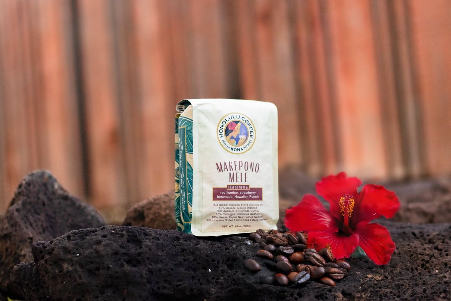 10oz bag of Makepono Mele with coffee beans and a hibiscus flower