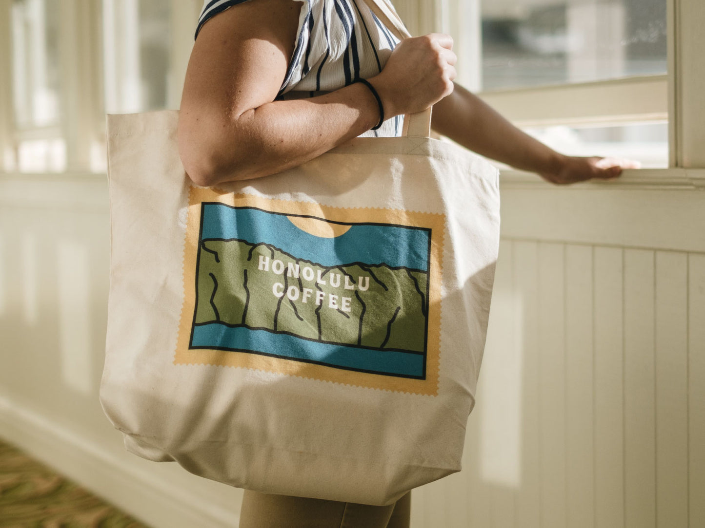 Our wide mauka tote being held by a window
