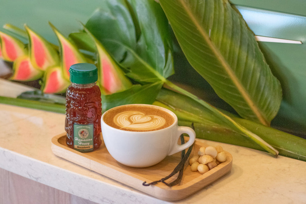Local latte on a wooden board with honey
