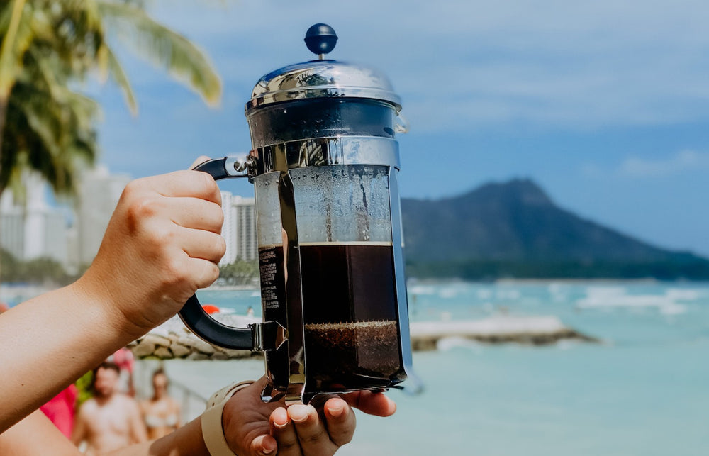 French Press coffee maker on the beach