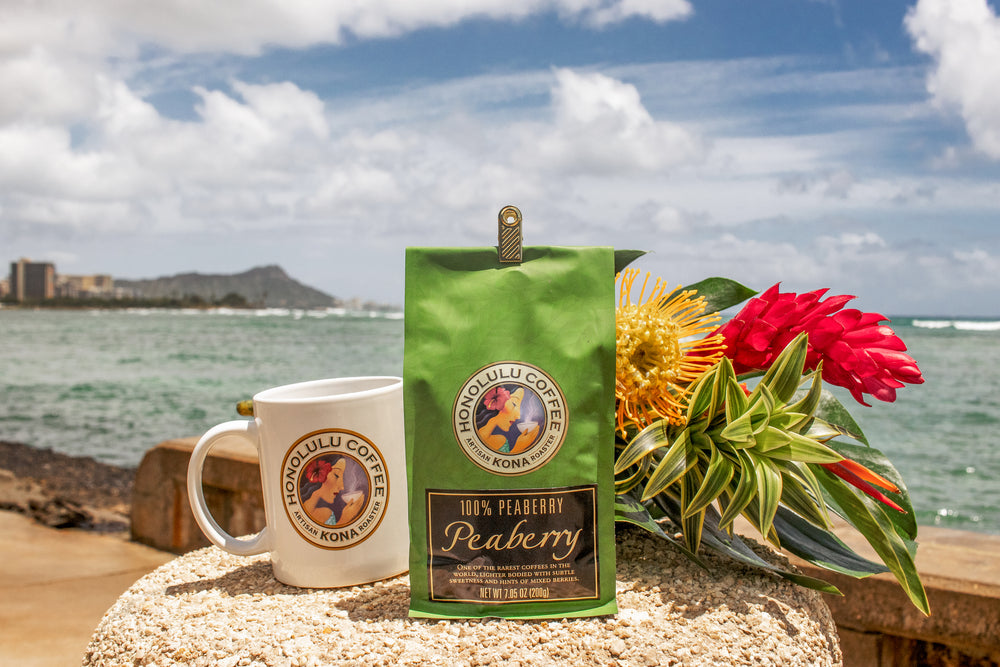 Kona Peaberry coffee on the beach with a view of Diamond Head in the back