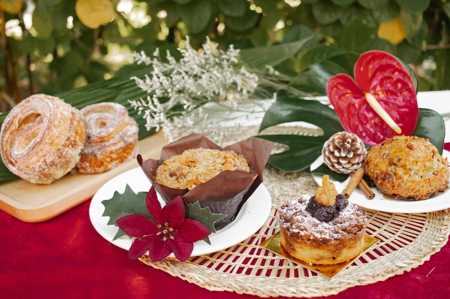 Group of seasonal pastries: Cinnamon Orange Morning Bun, White Chocolate Cranberry Muffin, Walnut Coffee Cake, and Spiced Maple Bacon Scone