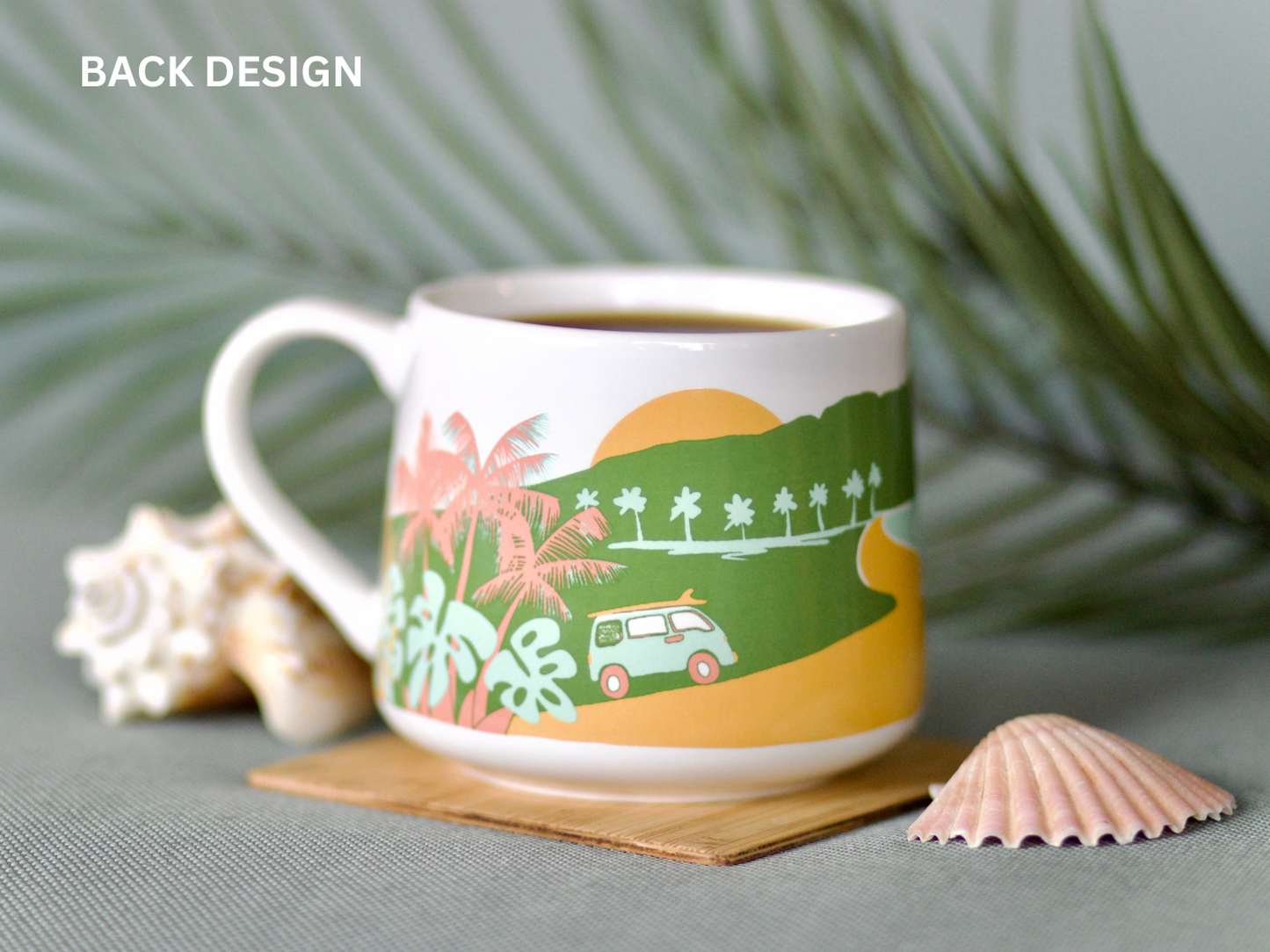 
                  
                    A mug full of coffee on a wooden coaster next to seashells. 
                  
                