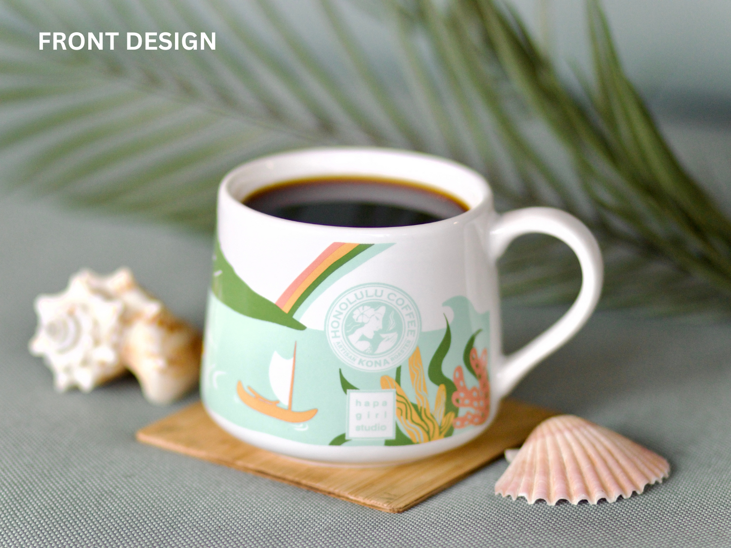 
                  
                    A mug full of coffee on a wooden coaster next to seashells. 
                  
                