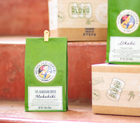 Green and brown coffee packages with Honolulu Coffee brand logo on steps
