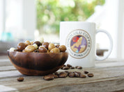 Mixed chocolate covered coffee beans sitting in a bowl next to a Honolulu Coffee Mug