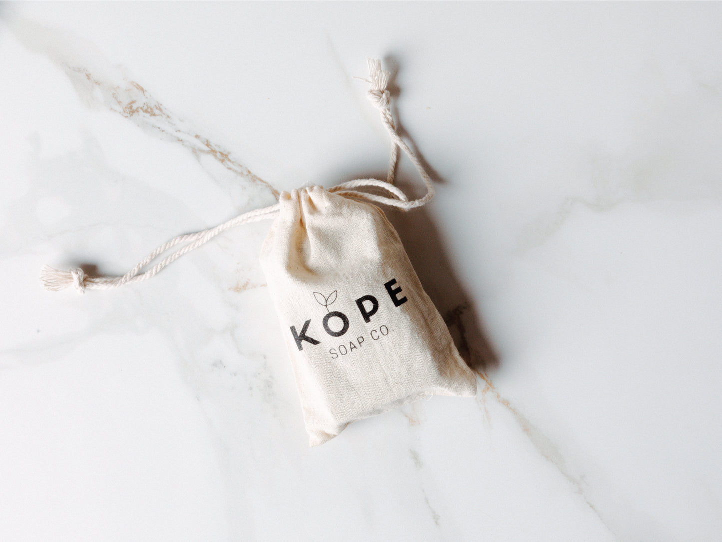 
                  
                    Kope soap in a branded bag on granite
                  
                