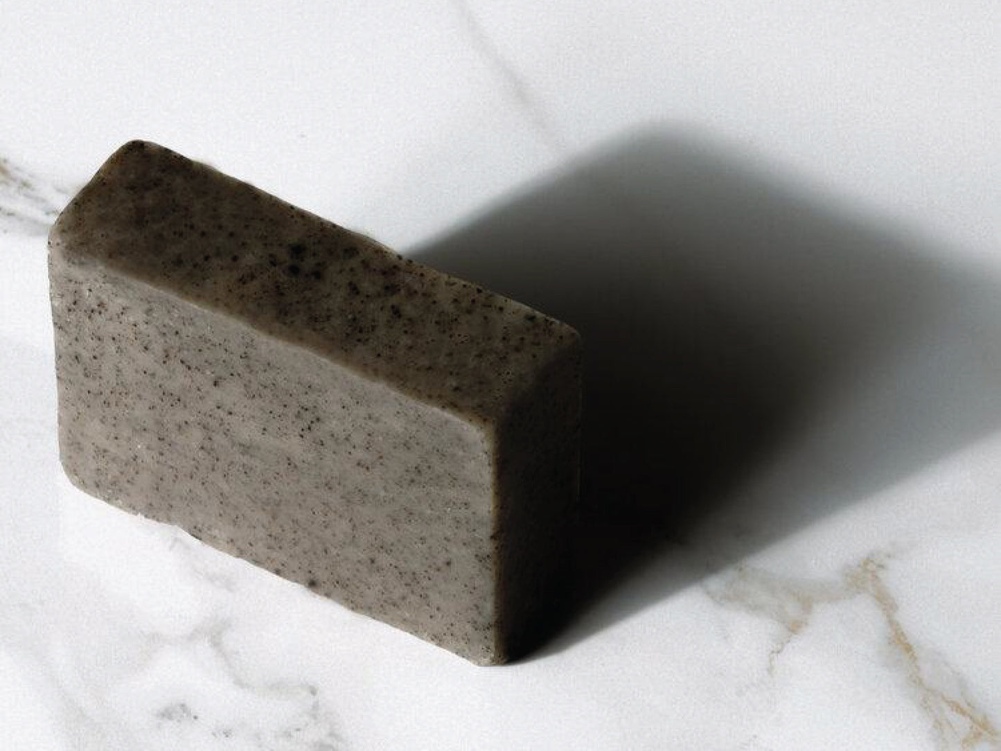 
                  
                    Bar of grey Kope soap on granite
                  
                